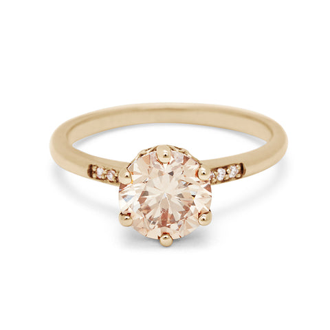 A solitaire ring with a round 1.50ct champagne diamond with white diamond pave on either side set in yellow gold., Yellow Gold 12