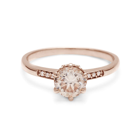 A solitaire ring with a round brilliant cut 0.75ct champagne diamond with white diamond pave on either side set in rose gold., Rose Gold 6