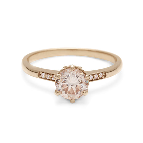 A solitaire ring with a round brilliant cut 0.75ct champagne diamond with white diamond pave on either side set in yellow gold., Yellow Gold 7
