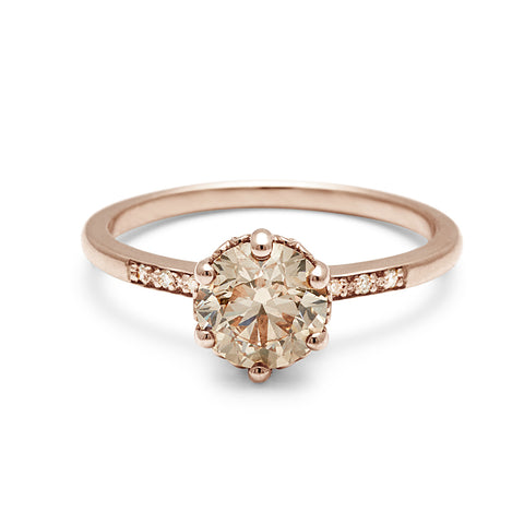 A solitaire ring with a round brilliant cut 1.00ct champagne diamond with white diamond pave on either side set in rose gold., Rose Gold