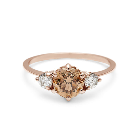 A three stone engagement ring with a round shape champagne diamond center stone with two white diamond round side stones set in rose gold., Rose Gold 3