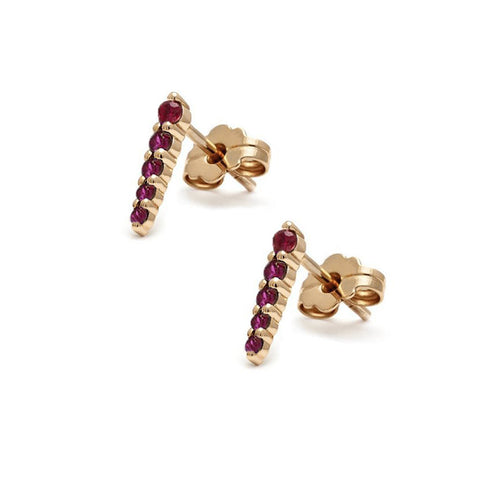 A pair of five ruby pointe earring studs set in yellow gold.