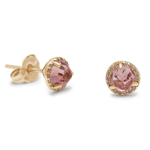 A pair of medium pink tourmaline center stone earrings with a halo of champagne diamonds set in yellow gold one earring angled. 2