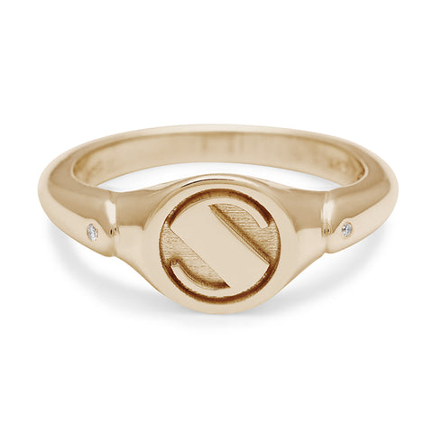 A monogrammed signet ring with a "S" on the front and two white diamond accents on either side and set in yellow gold.