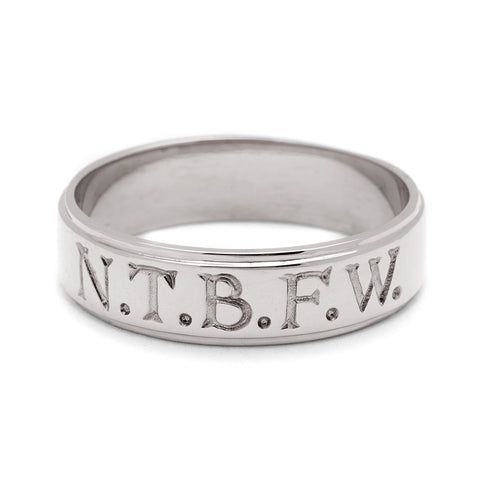 A white gold 6mm flat edge band with "N.T.B.F.W." engraved on the outside., White Gold 3