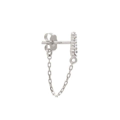 A single earring with four white diamonds with a chain connecting to the ear back set in white gold. 6