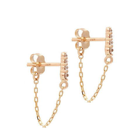 A pair of earrings with four champagne diamonds with a chain connecting to the ear back set in yellow gold., Yellow Gold