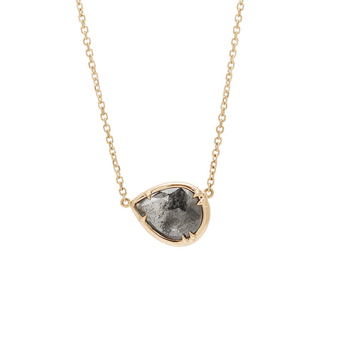 A pear necklace with a grey diamond set in bezel with claw prongs in yellow gold with a yellow gold chain.