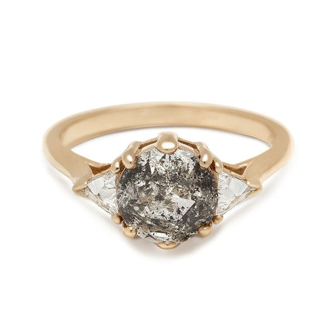 A three stone engagement ring with a round shape 1.72ct grey diamond center stone with two white diamond trillion side stones set in yellow gold.