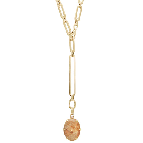 A quartz charm in a bezel setting with claw prongs set in yellow gold with champagne diamond accent stone on a mixed link yellow gold chain.