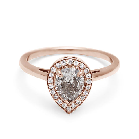 An engagement ring with a pear shape grey diamond center stone surrounded by a white diamond pave halo set in rose gold., Rose Gold 3