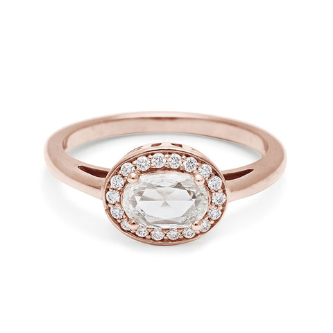 An engagement ring with a rose cut and oval shape white diamond center stone surrounded by a white diamond pave halo set in rose gold., Rose Gold 3