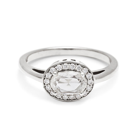 An engagement ring with a rose cut and oval shape white diamond center stone surrounded by a white diamond pave halo set in white gold., White Gold 4