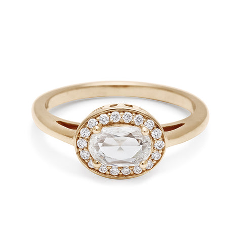 An engagement ring with a rose cut and oval shape white diamond center stone surrounded by a white diamond pave halo set in yellow gold., Yellow Gold