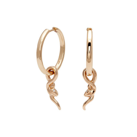 A pair of hoop earrings with a serpent charm at the bottom set in yellow gold one earring angled.