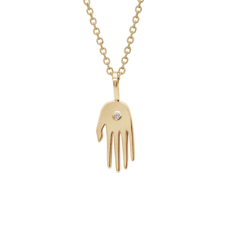 A small hand pendant in yellow gold with a white diamond accent stone on a yellow gold chain.