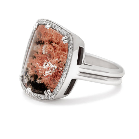 Angled view of a square quartz surrounded by white diamond pave halo ring set in white gold.