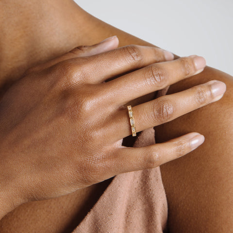 A white diamond baguette band that has diamond goes around 3/4 of the band set in yellow gold on a medium-complexion right hand ring finger., White Gold, Rose Gold, Yellow Gold 4