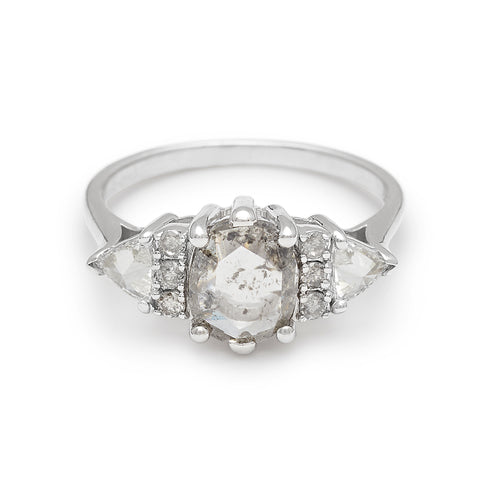 A round shape grey diamond center stone ring with three round grey diamonds on either and two white diamond trillions on the outer edges of each side set in white gold.