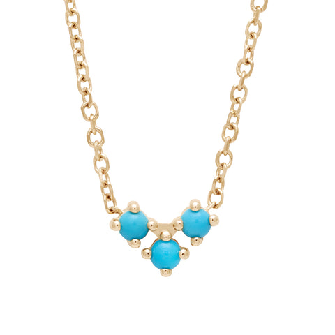 A 16" chain necklace with three turquoise stones in the shape of an arrow at the base set in yellow gold.