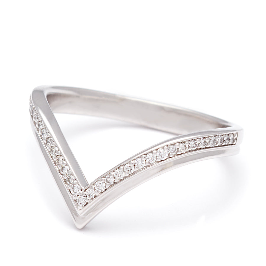 Angled view of a chrysalis band with white diamonds set in white gold.