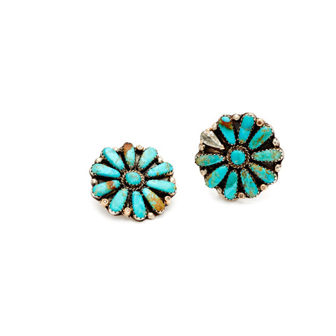 A pair of flower shaped stud earrings with turquoise stones with champagne diamond accent stones set in sterling silver.