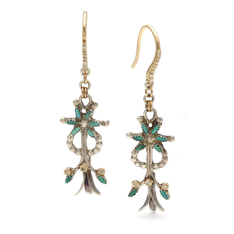 A pair of squash blossom earrings with turquoise stones and white diamonds set in yellow gold and sterling silver.