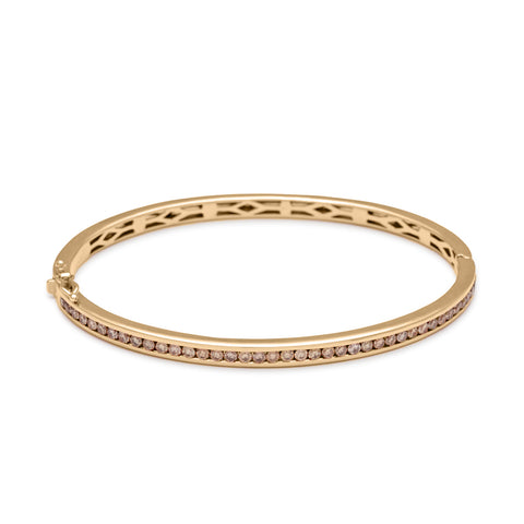 A bracelet with a line of champagne diamonds set around the band set in yellow gold., Yellow Gold