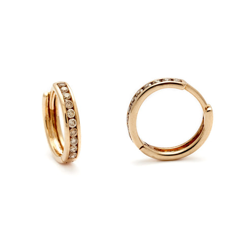 A pair of hoops with a line of champagne diamonds set in yellow gold one earring is angled. 4