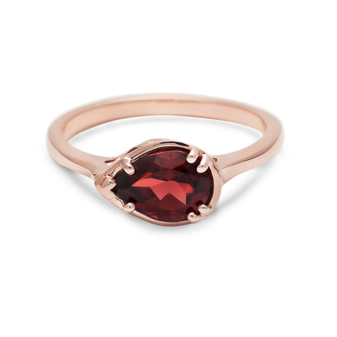 A pear shaped ring with a garnet stone set in rose gold., Rose Gold