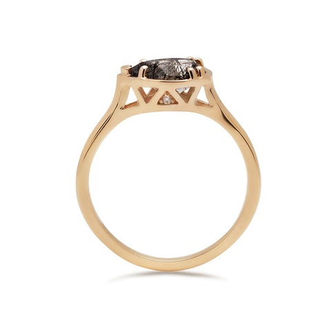 Side view of a pear shaped ring with a black rutilated stone set in yellow gold. 2
