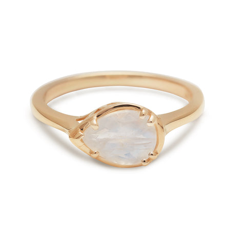 A pear shaped ring with a rainbow moonstone set in yellow gold.