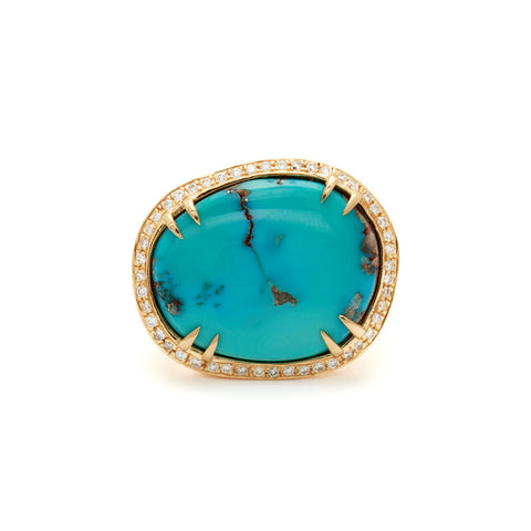 An oval shape turquoise center stone with double claw prongs surrounded by a white diamond pave halo set in yellow gold.