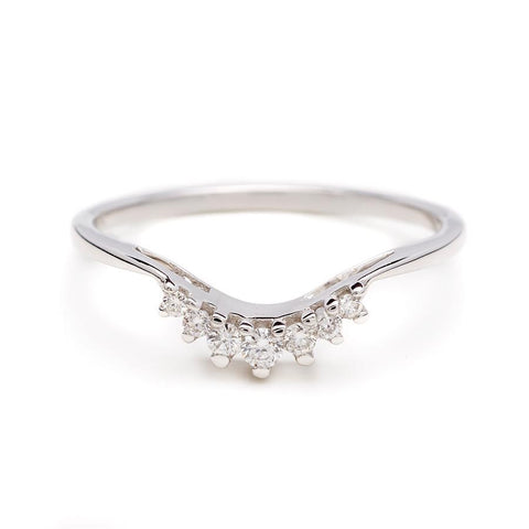 A curved band with 7 white diamonds in ascending and descending size set in platinum.
