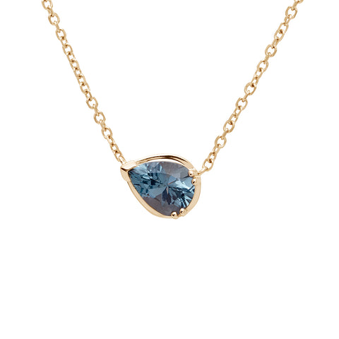 A necklace with a pear pendant with a grey spinel set in yellow gold with a yellow gold chain.