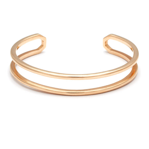 A doubled banded cuff bracelet set in yellow gold.