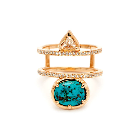 A double banded ring with white diamond pave around both bands with a champagne diamond trillion on the top and an oval turquoise stone set in bezel with claw prongs in yellow gold.