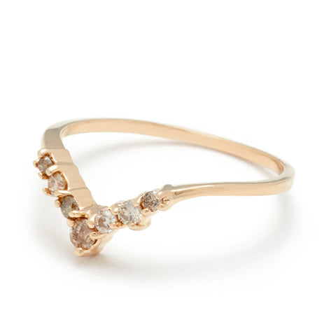 Angled view of a band with champagne diamonds in ascending size set in yellow gold. 4